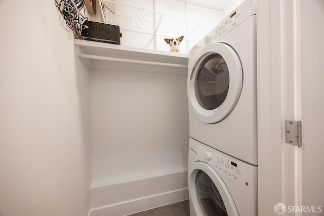 laundry room featuring stacked washer and dryer and laundry area