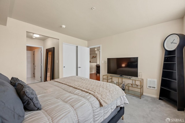 bedroom with visible vents, baseboards, and carpet