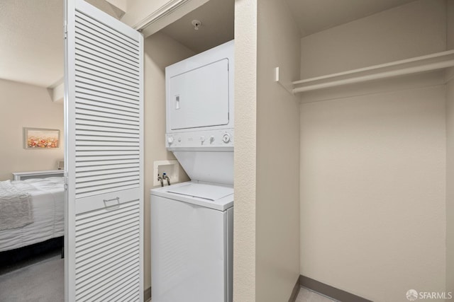 washroom featuring laundry area and stacked washer and clothes dryer