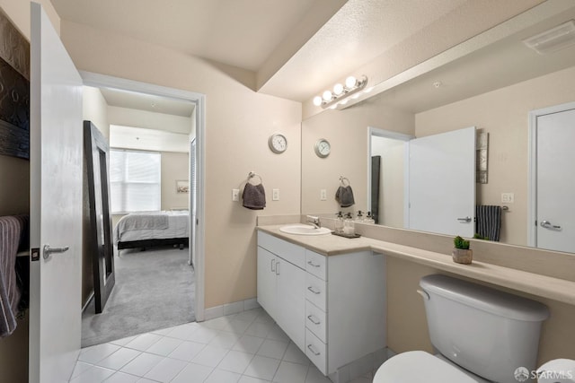 ensuite bathroom featuring tile patterned floors, visible vents, toilet, ensuite bath, and vanity