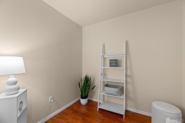 interior space with baseboards and wood finished floors