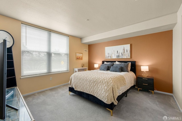 bedroom with baseboards and carpet