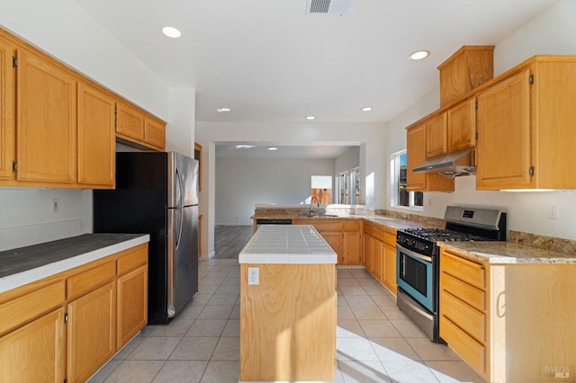 kitchen featuring light tile patterned floors, a kitchen island, sink, and appliances with stainless steel finishes