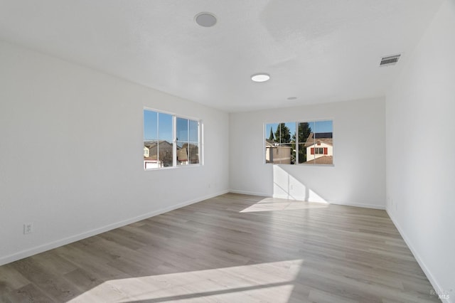 empty room featuring a healthy amount of sunlight and light wood-type flooring