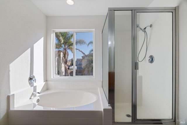 bathroom featuring separate shower and tub