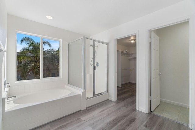 bathroom with separate shower and tub and hardwood / wood-style floors