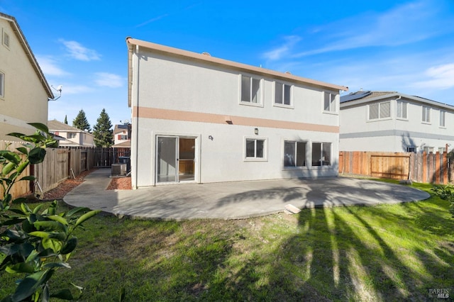 rear view of property with a patio, central AC, and a lawn