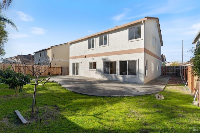 back of property featuring a yard and a patio area