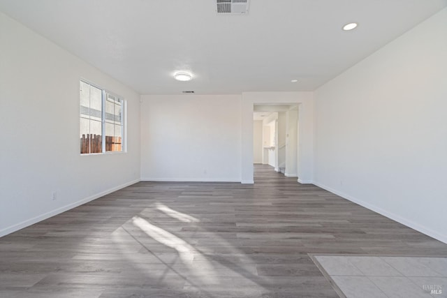 unfurnished room with wood-type flooring