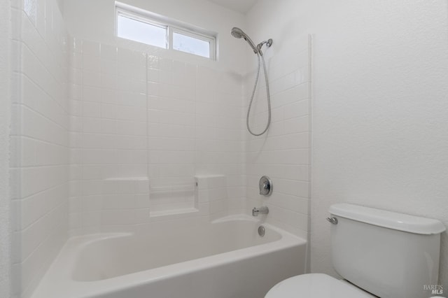 bathroom with washtub / shower combination and toilet