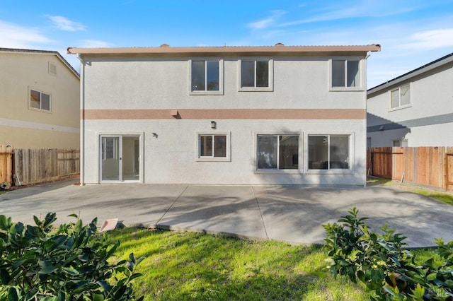 rear view of house featuring a patio