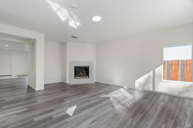 unfurnished living room featuring hardwood / wood-style flooring and a fireplace