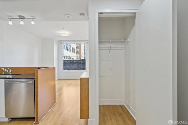 interior space featuring sink, light hardwood / wood-style flooring, and dishwasher