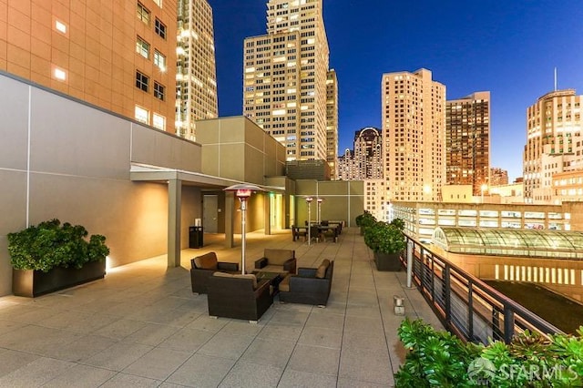 patio at night featuring an outdoor hangout area