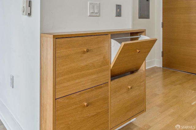 interior details featuring electric panel and hardwood / wood-style floors