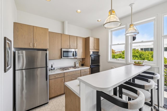 3364 21st St, San Francisco, CA 94110 - kitchen with appliances with stainless steel finishes, light countertops, a breakfast bar area, recessed lighting, and pendant lighting