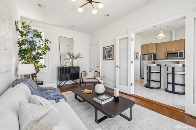 3364 21st St, San Francisco, CA 94110 - living area with light wood finished floors and a chandelier