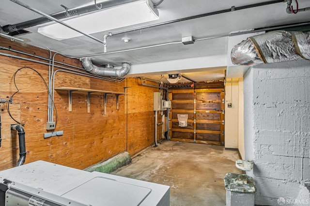 below grade area featuring electric panel and a garage