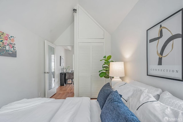 bedroom featuring a closet, lofted ceiling, and wood finished floors