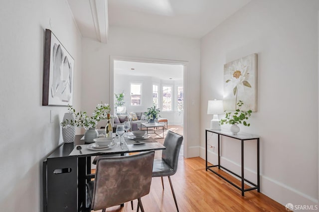 dining room with light wood finished floors and baseboards