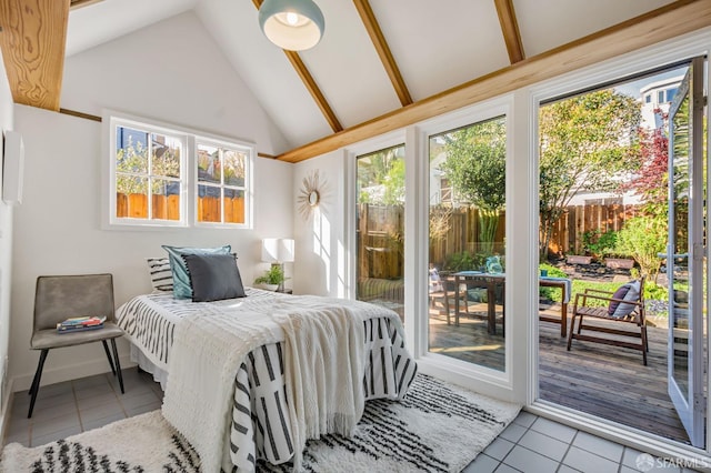 tiled bedroom featuring lofted ceiling and access to outside