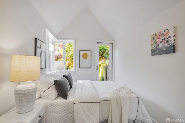 bedroom with access to outside and vaulted ceiling