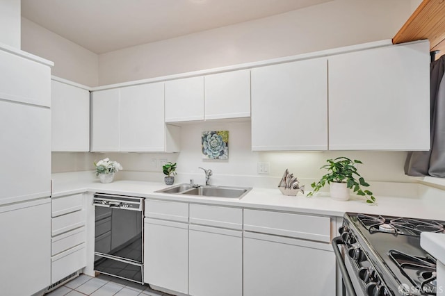 kitchen with white cabinetry, light countertops, black dishwasher, and a sink