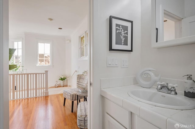 bathroom with vanity and wood finished floors