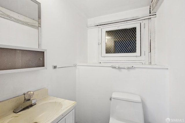 bathroom with toilet and vanity