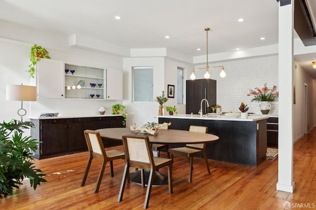 dining area with light hardwood / wood-style floors and sink