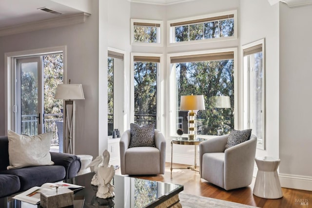 living room featuring hardwood / wood-style flooring and ornamental molding