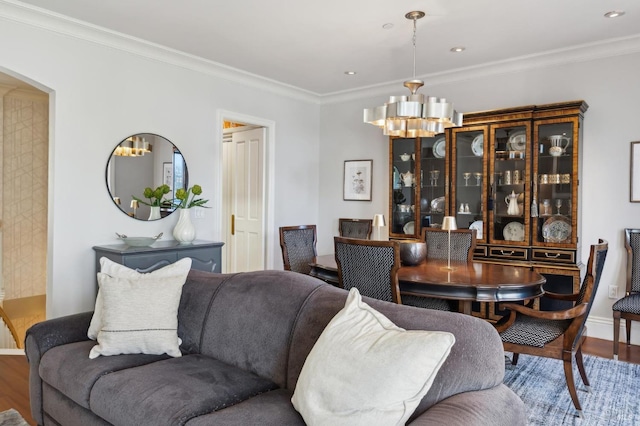 living room featuring a chandelier, crown molding, and wood-type flooring