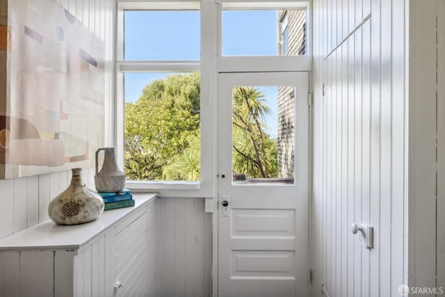 doorway featuring wood walls