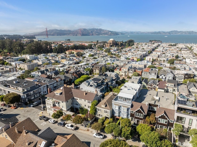 drone / aerial view featuring a water and mountain view