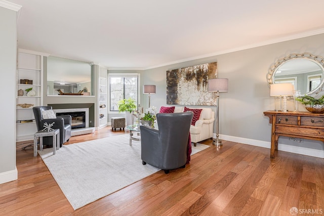 living room with ornamental molding and light wood-type flooring