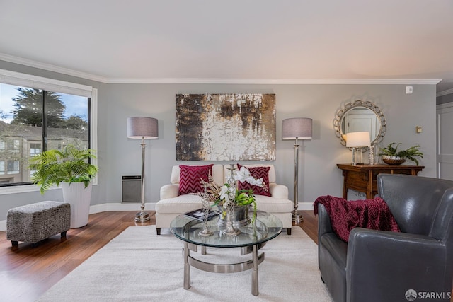 living room with wood-type flooring and crown molding