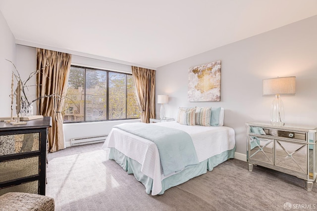 bedroom with baseboard heating and carpet flooring