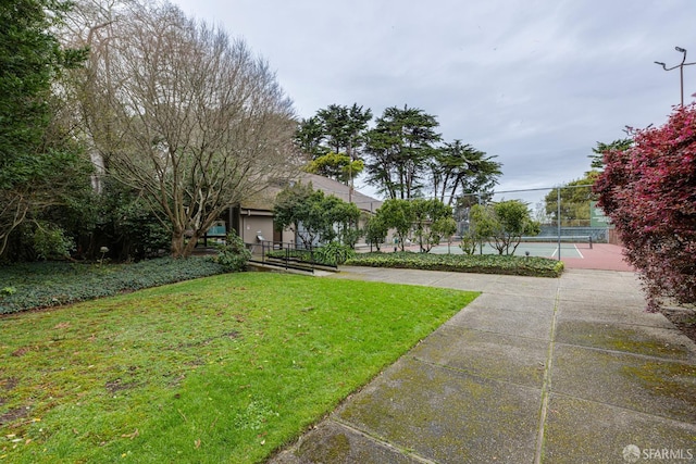 exterior space featuring a yard and tennis court