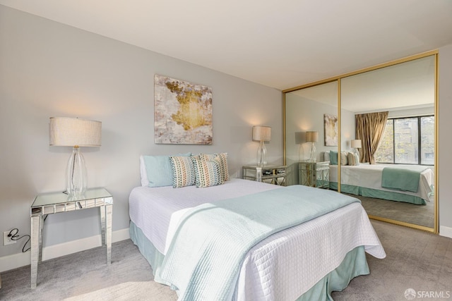 bedroom with a closet and light colored carpet