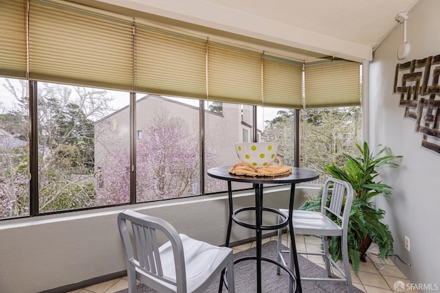 sunroom featuring vaulted ceiling