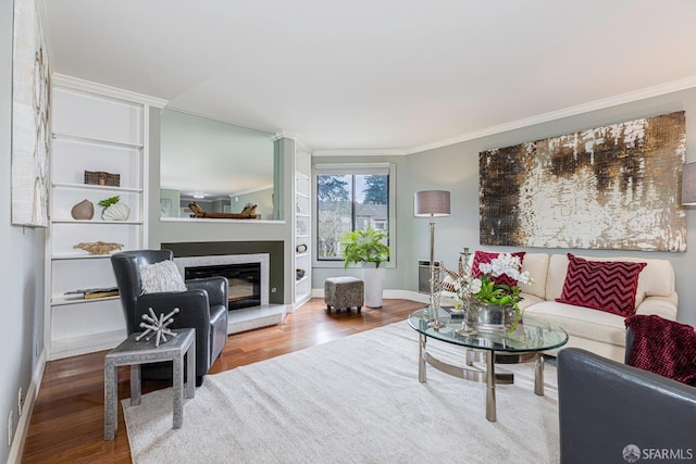 living room featuring hardwood / wood-style floors and crown molding