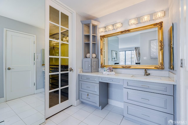 bathroom with tile patterned floors, french doors, and vanity