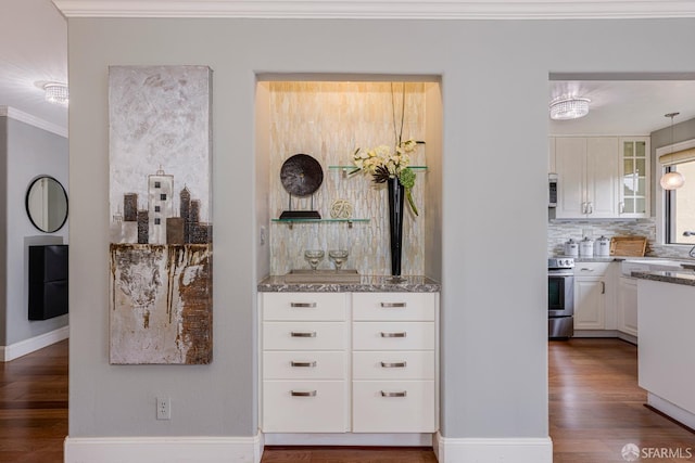 interior space featuring white cabinetry, stainless steel range with electric stovetop, dark wood-type flooring, and crown molding