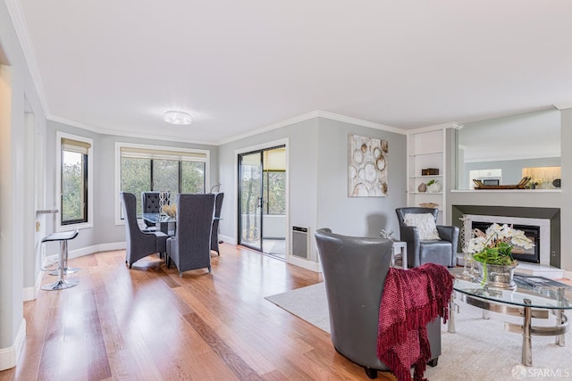 living room with light wood-type flooring and crown molding