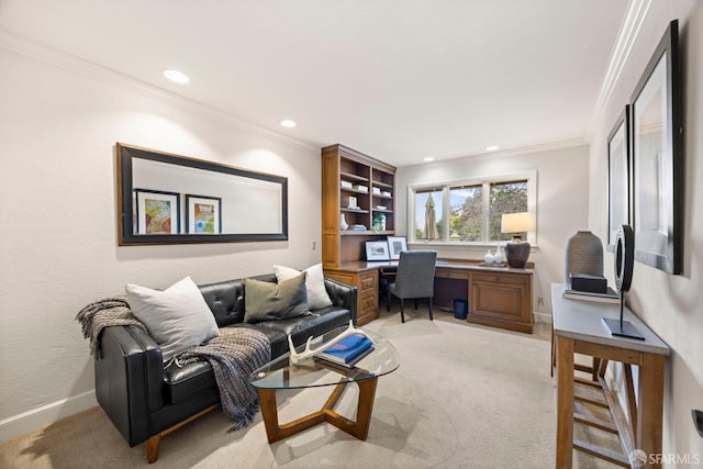 office area featuring baseboards, ornamental molding, built in desk, and light colored carpet