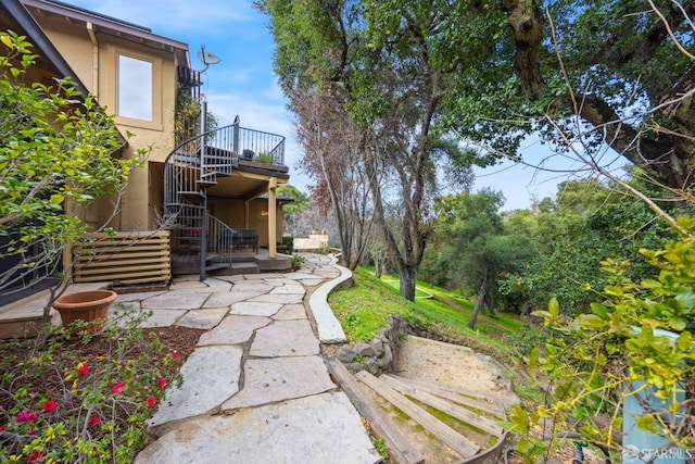 view of yard featuring a patio and stairs