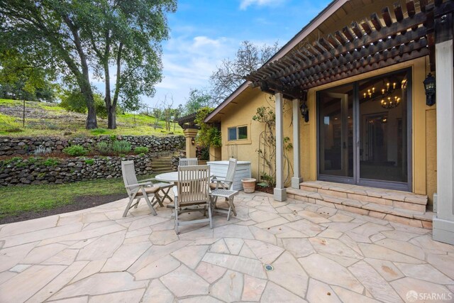 view of patio / terrace featuring entry steps, outdoor dining space, and a pergola