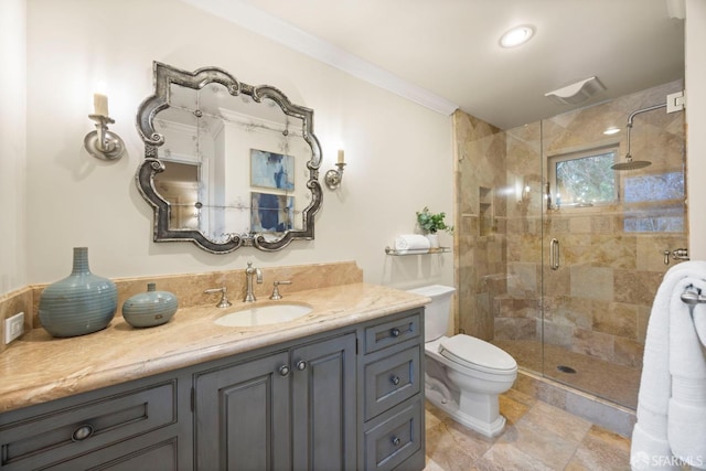 bathroom with toilet, a shower stall, ornamental molding, and vanity