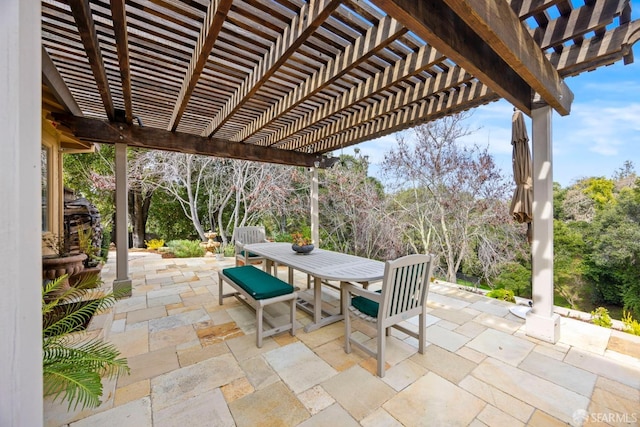 view of patio with outdoor dining space and a pergola