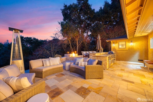 view of patio with an outdoor living space with a fire pit